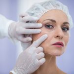 doctor examining female patients face cosmetic treatment 107420 74121