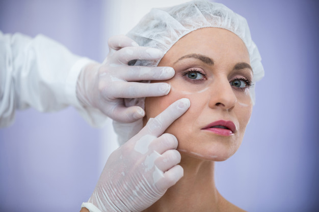 doctor examining female patients face cosmetic treatment 107420 74121